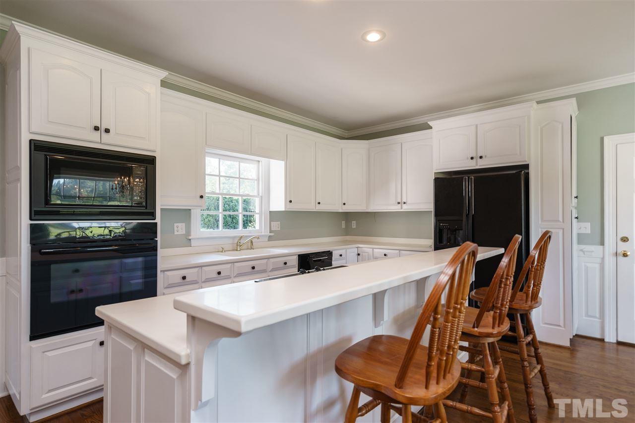 8446 Seven Paths Road Spring Hope, NC 27882 - Photo 7 of 24 a kitchen that has a cabinets counter space and appliances