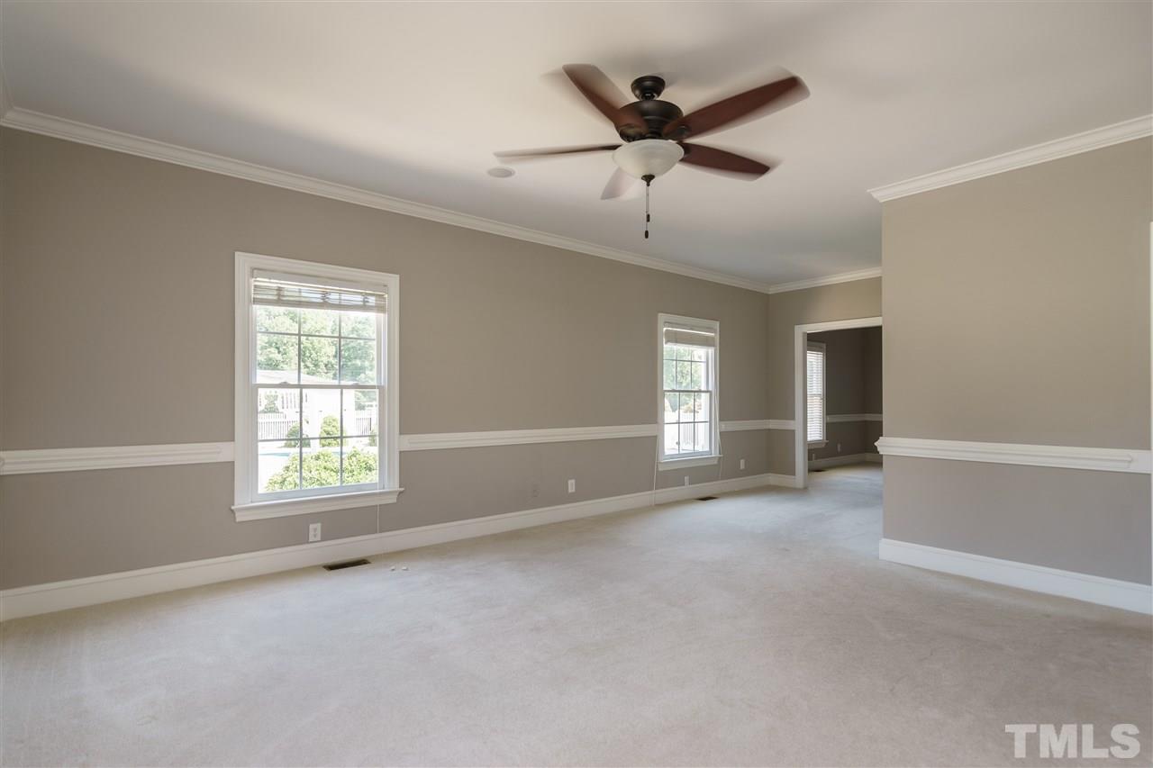 8446 Seven Paths Road Spring Hope, NC 27882 - Photo 9 of 24 an empty room with windows and ceiling fan
