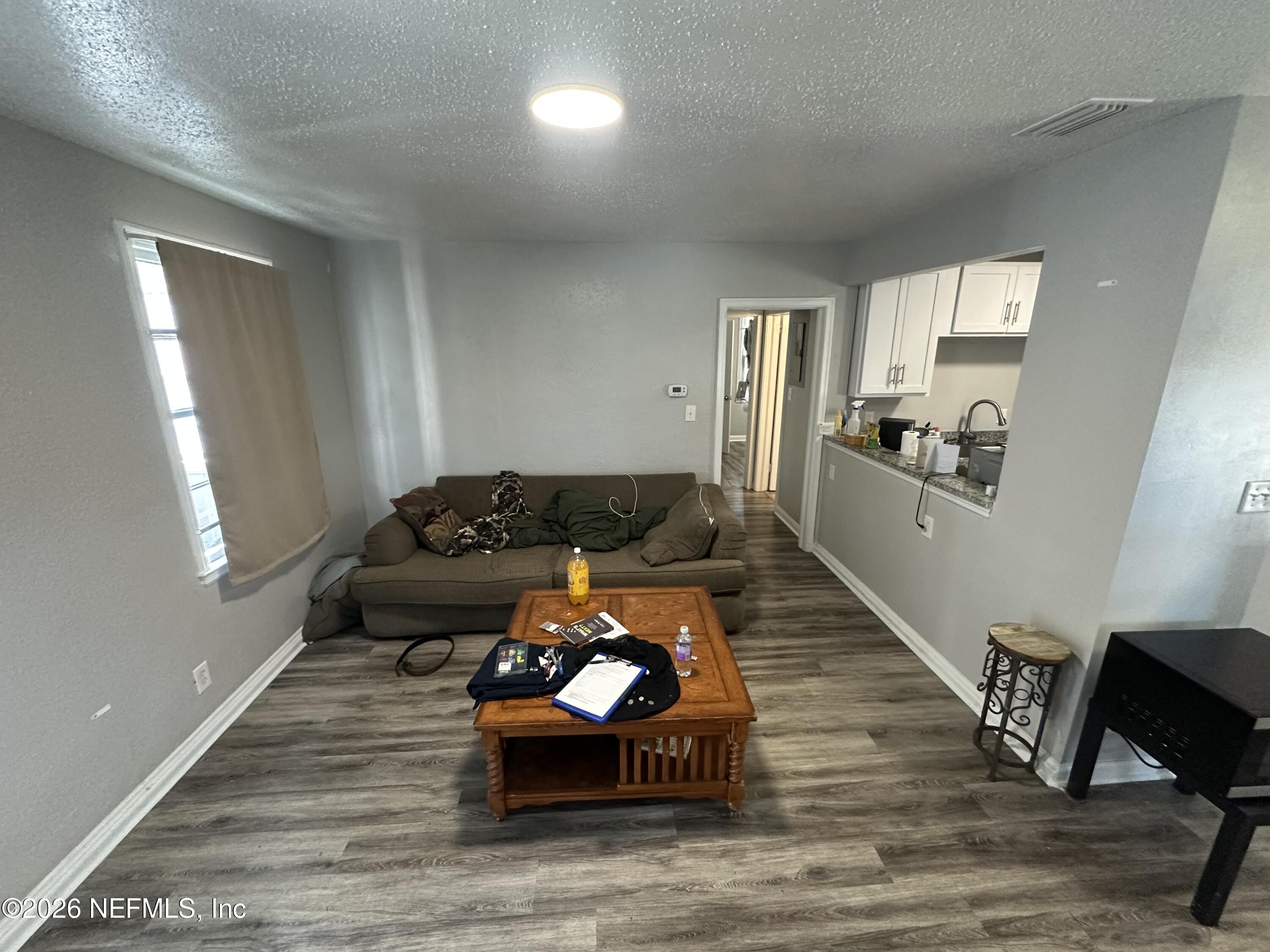1804 Cleveland Street Jacksonville, FL 32209 - Photo 5 of 14 a living room with furniture and wooden floor