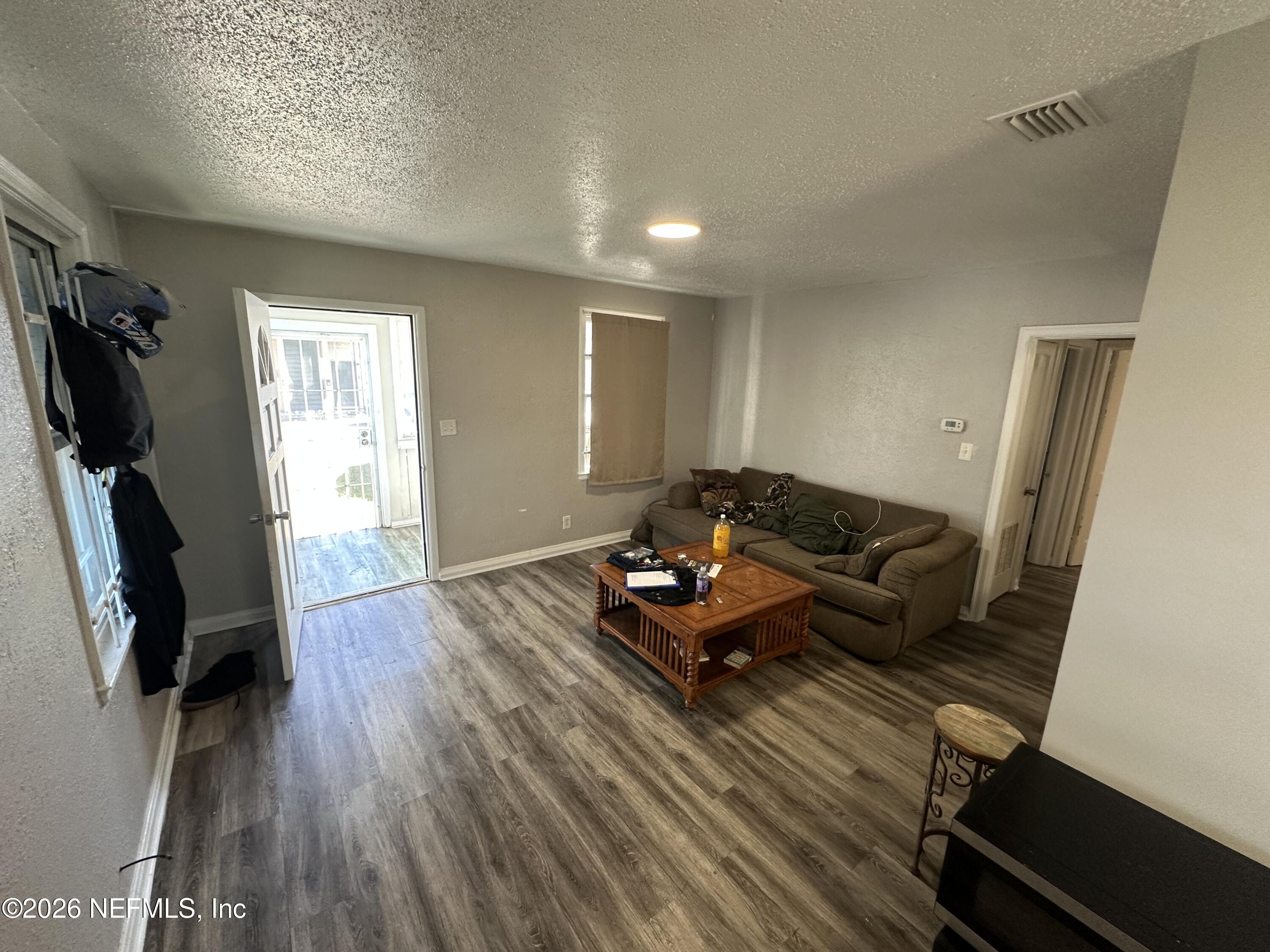 1804 Cleveland Street Jacksonville, FL 32209 - Photo 6 of 14 a living room with furniture a flat screen tv and a window