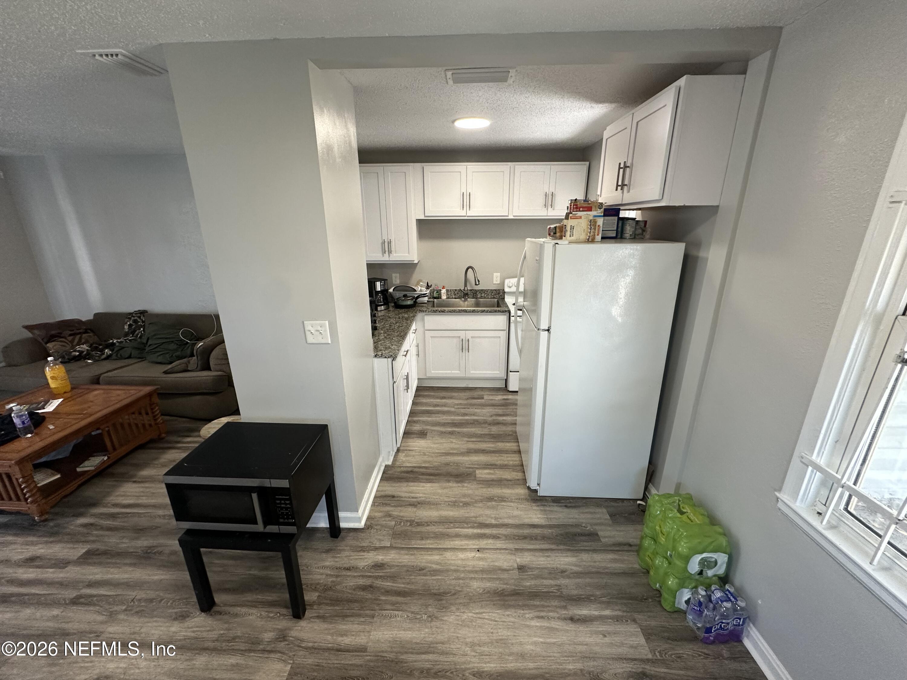 1804 Cleveland Street Jacksonville, FL 32209 - Photo 7 of 14 a kitchen with a refrigerator a sink and wooden floor