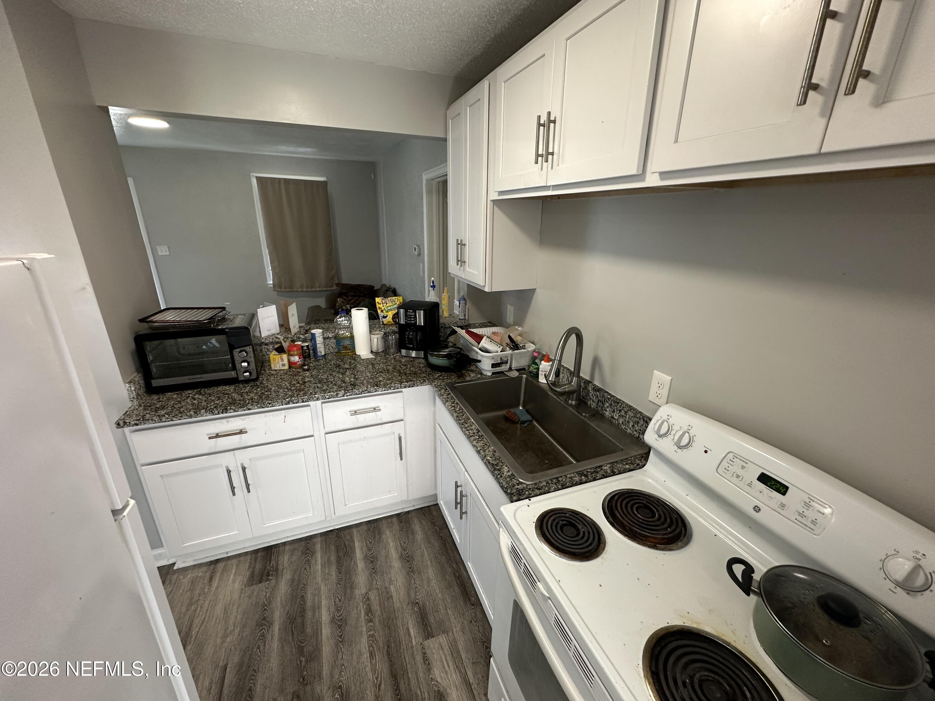1804 Cleveland Street Jacksonville, FL 32209 - Photo 9 of 14 a kitchen with a sink a stove and cabinets