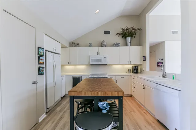 a white stove top oven sitting inside of a kitchen