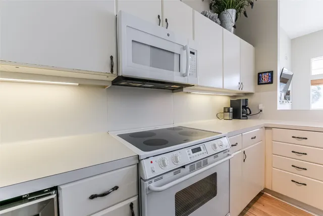 a hallway with furniture and a large window