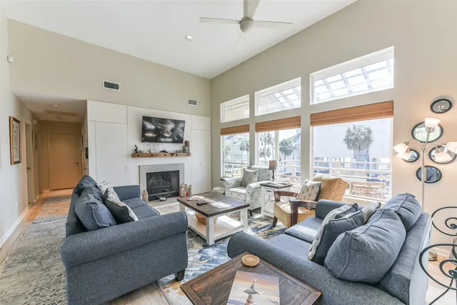 a living room with fireplace furniture and a floor to ceiling window