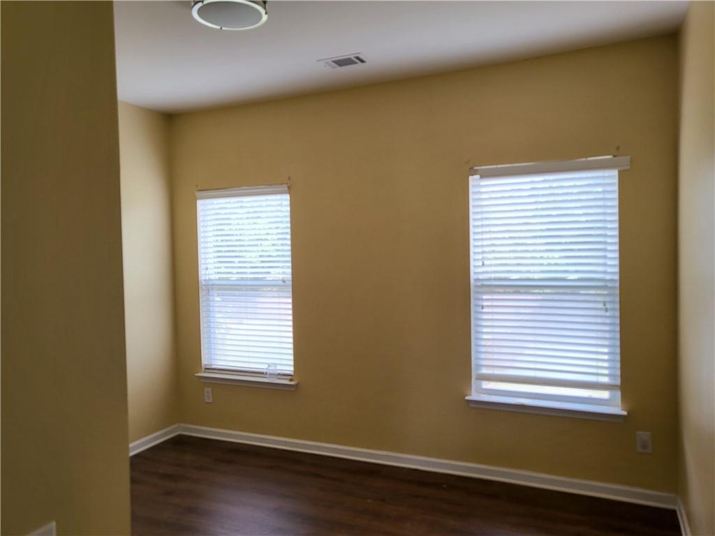 950 Rockbass Road Suwanee, GA 30024 - Photo 11 of 33 a view of a room with wooden floor and windows