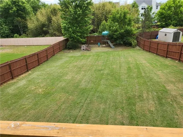 a backyard of a house with table and chairs