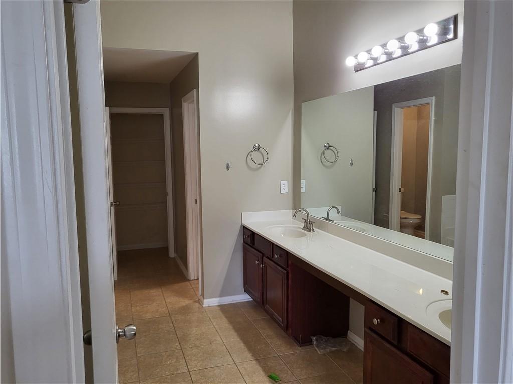 950 Rockbass Road Suwanee, GA 30024 - Photo 19 of 33 a bathroom with a double vanity sink and a mirror