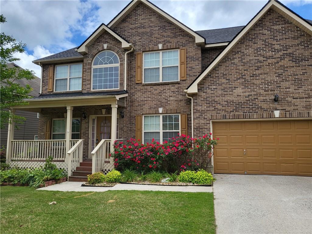 950 Rockbass Road Suwanee, GA 30024 - Photo 2 of 33 a front view of a house with a garden and plants