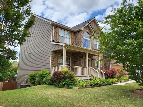 a front view of a house with garden