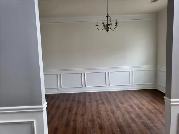 a view of room with wooden floor