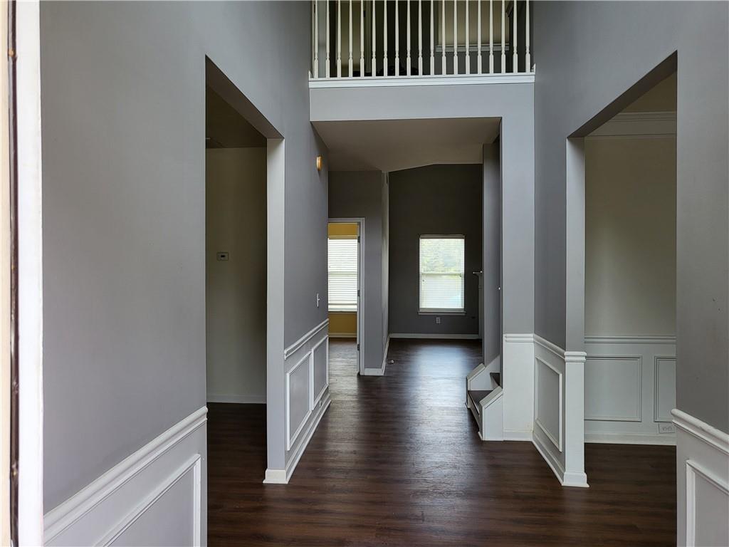 950 Rockbass Road Suwanee, GA 30024 - Photo 5 of 33 a view of a hallway with wooden floor and staircase