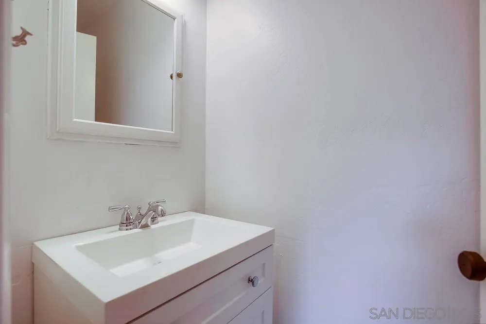 1228 Evergreen Drive Cardiff, CA 92007 - Photo 16 of 37 a bathroom with a sink and a mirror
