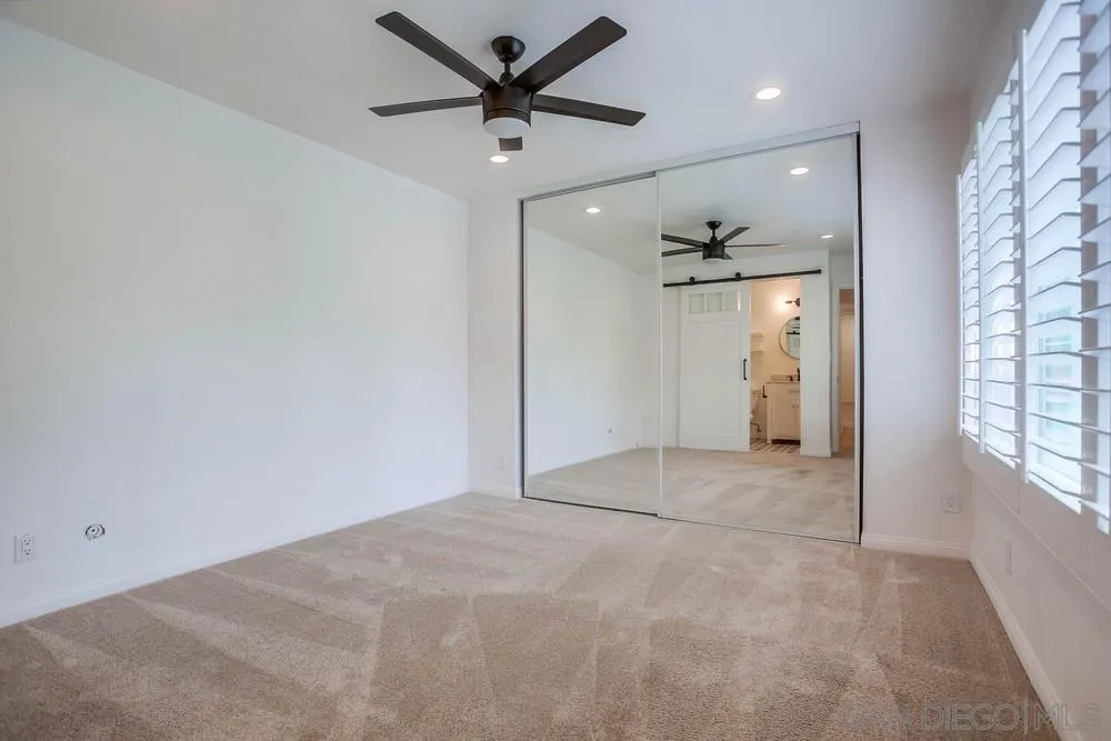 1228 Evergreen Drive Cardiff, CA 92007 - Photo 27 of 37 an empty room with windows and a ceiling fan