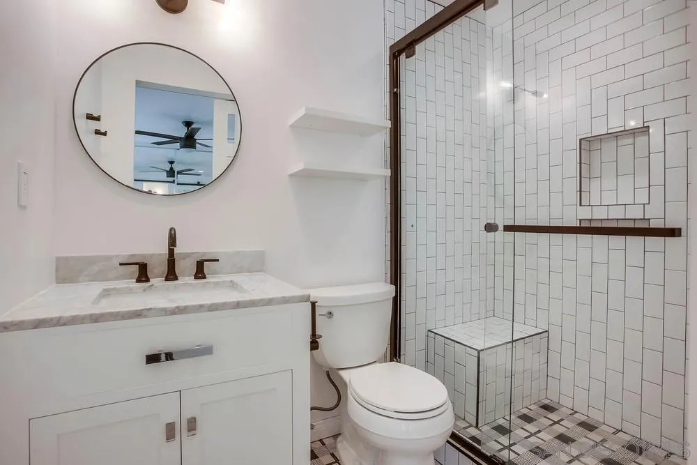 1228 Evergreen Drive Cardiff, CA 92007 - Photo 31 of 37 a bathroom with a granite countertop toilet sink mirror and vanity