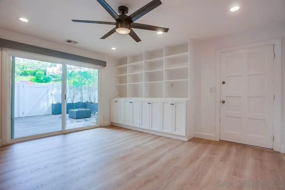 1228 Evergreen Drive Cardiff, CA 92007 - Photo 7 of 37 an empty room with wooden floor and windows