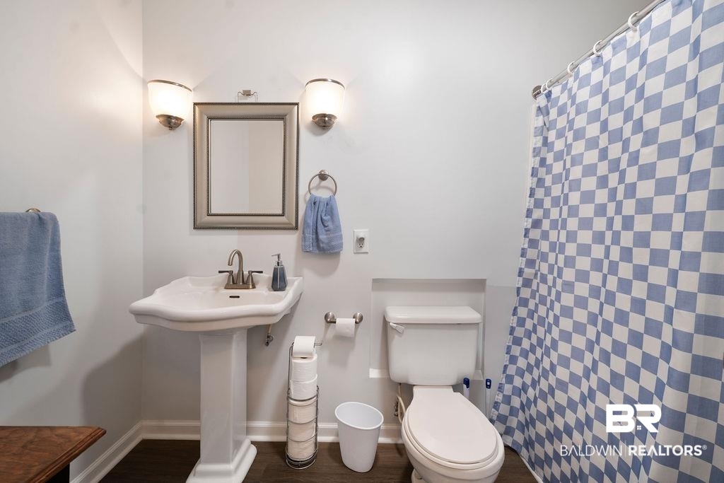 11901 Old Moffat Road Wilmer, AL 36587 - Photo 13 of 39 Bathroom with curtained shower and dark wood-style floors