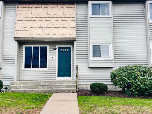a view of a house with a yard and a large window
