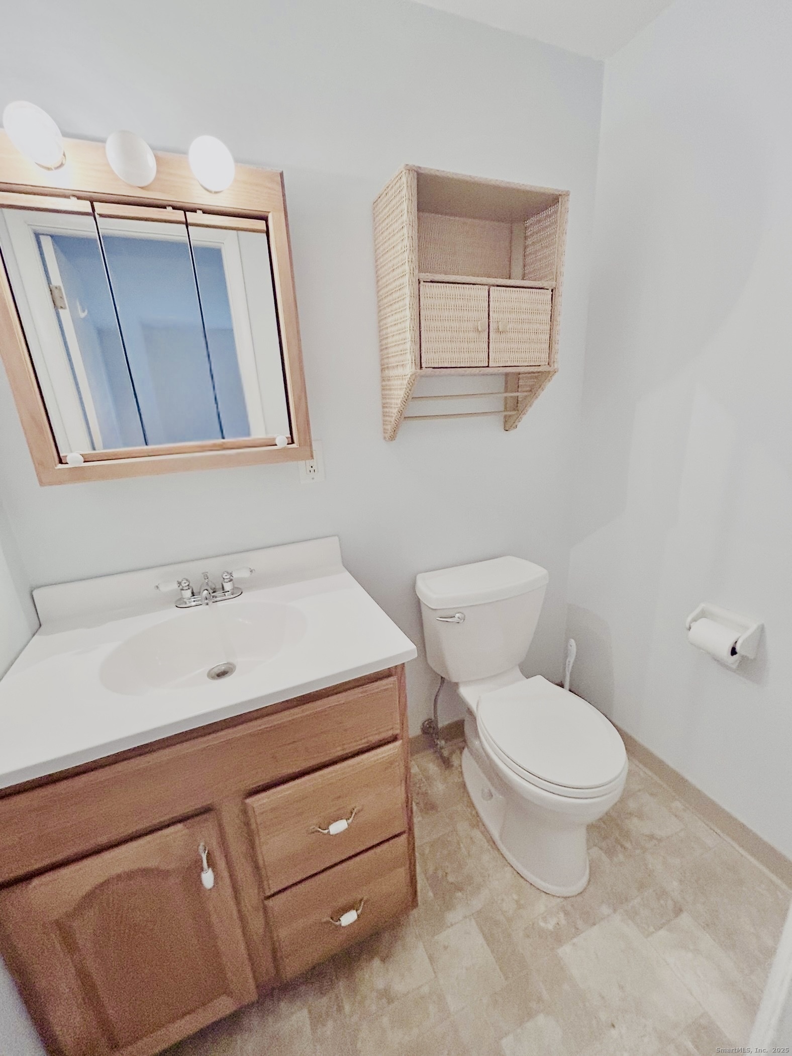 4 Carillon Drive, Unit B Rocky Hill, CT 06067 - Photo 11 of 16 a bathroom with a toilet sink and mirror