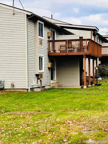 a view of a house with pool and a yard