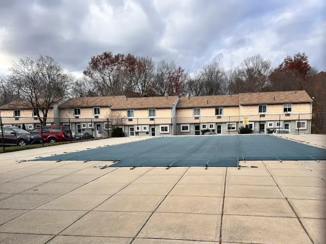 a view of houses with cars parked