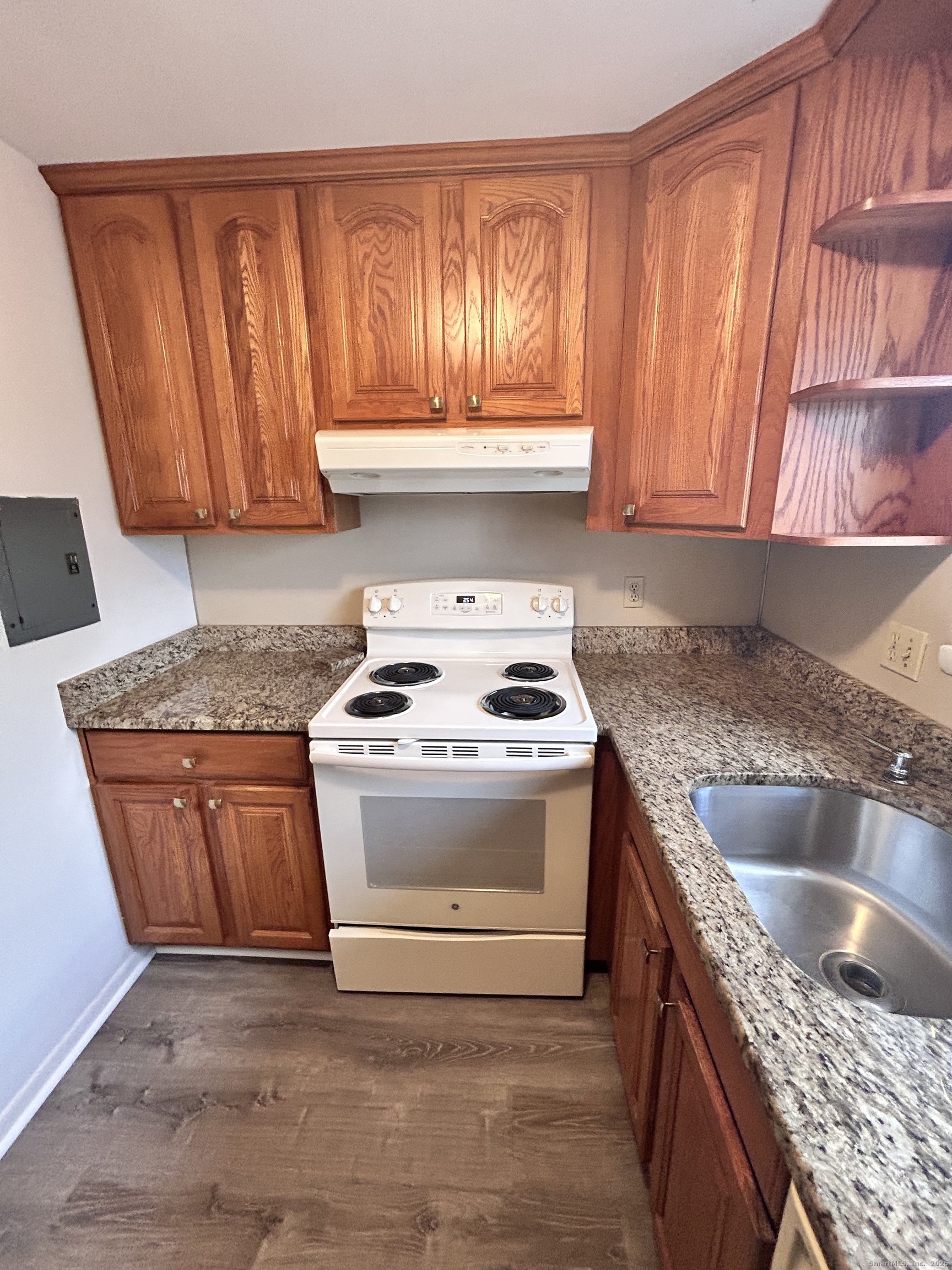 4 Carillon Drive, Unit B Rocky Hill, CT 06067 - Photo 4 of 16 a kitchen with granite countertop a sink stove and cabinets