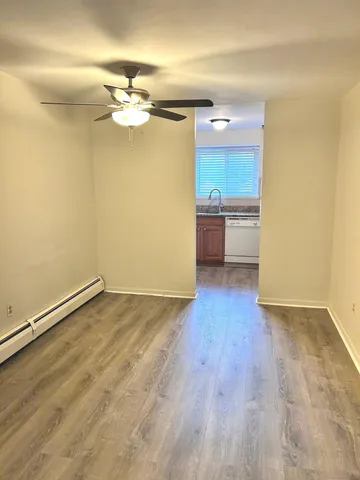 a view of a kitchen with a sink and a refrigerator