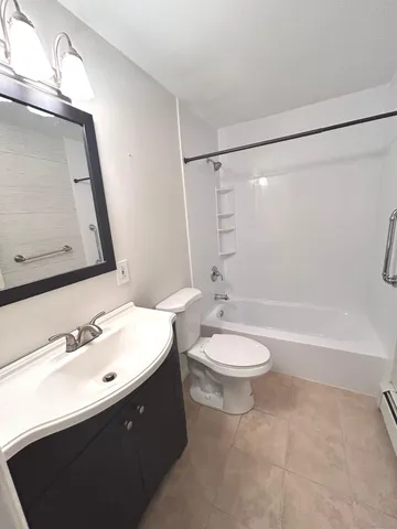 a bathroom with a double vanity sink toilet and shower
