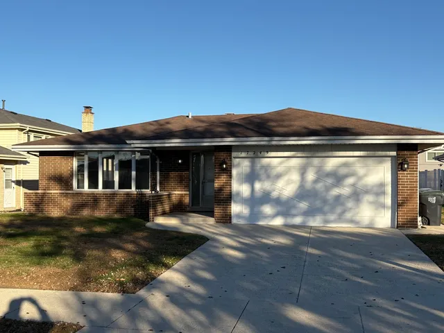 a view of house with a yard