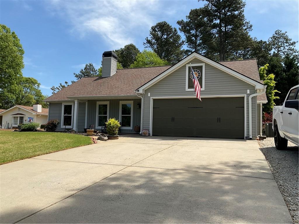 5403 Stone Trace Gainesville, GA 30504 - Photo 2 of 126 a front view of a house with a yard and garage