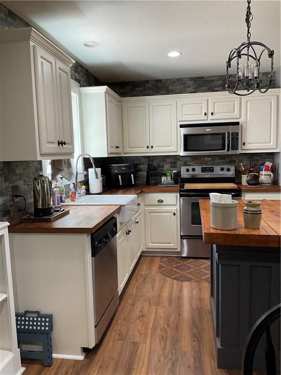 5403 Stone Trace Gainesville, GA 30504 - Photo 32 of 126 a kitchen with stainless steel appliances kitchen island granite countertop a sink a stove top oven a counter space and cabinets