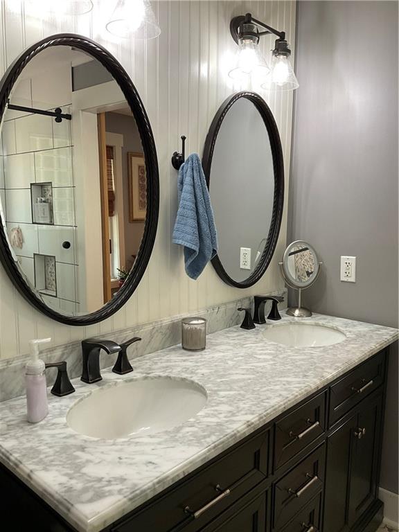 5403 Stone Trace Gainesville, GA 30504 - Photo 55 of 126 a bathroom with a granite countertop toilet a sink and a mirror