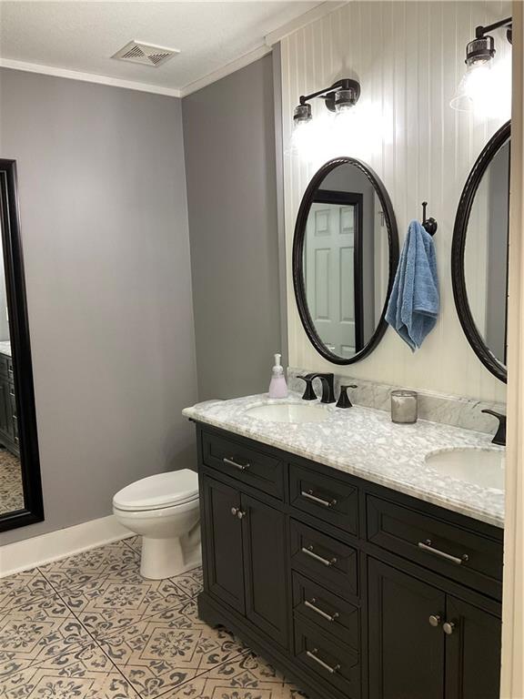 5403 Stone Trace Gainesville, GA 30504 - Photo 56 of 126 a bathroom with a granite countertop toilet a sink and a mirror