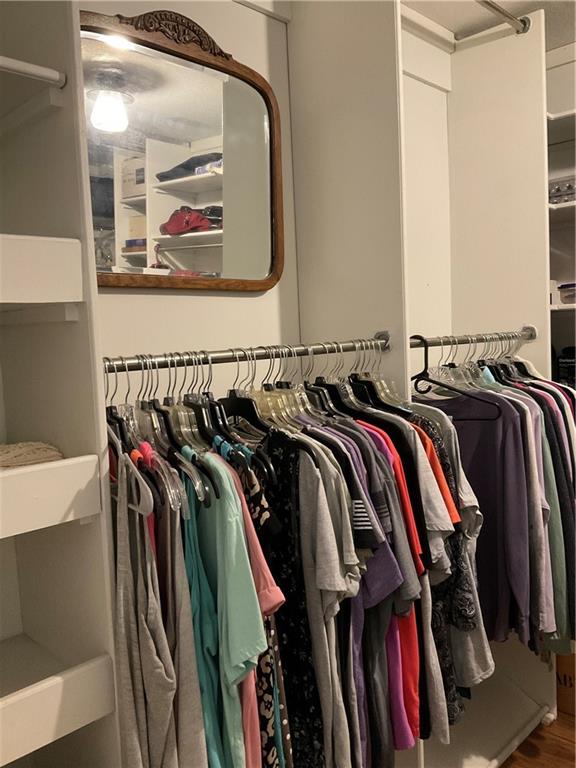 5403 Stone Trace Gainesville, GA 30504 - Photo 67 of 126 a view of walk in closet with clothes and shoes