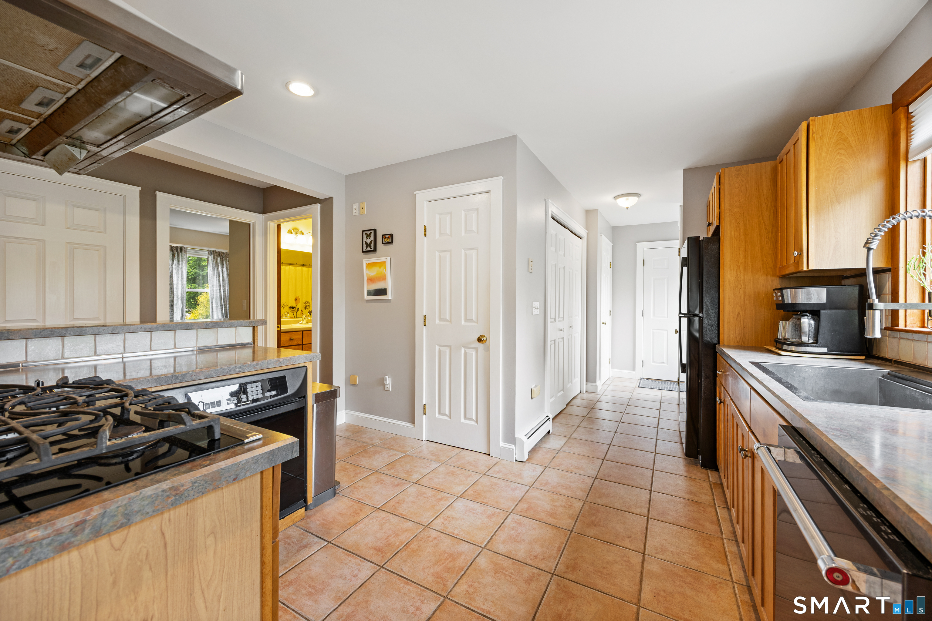 694 Millbrook Road Middletown, CT 06457 - Photo 9 of 34 a kitchen with stainless steel appliances granite countertop a stove and a sink