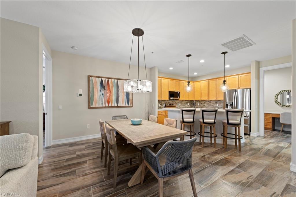 9076 Rialto Street, Unit 6204 Naples, FL 34113 - Photo 10 of 50 Open-concept dining and kitchen area featuring wood-finish tile flooring. NEW TILE FLOOR (2018)