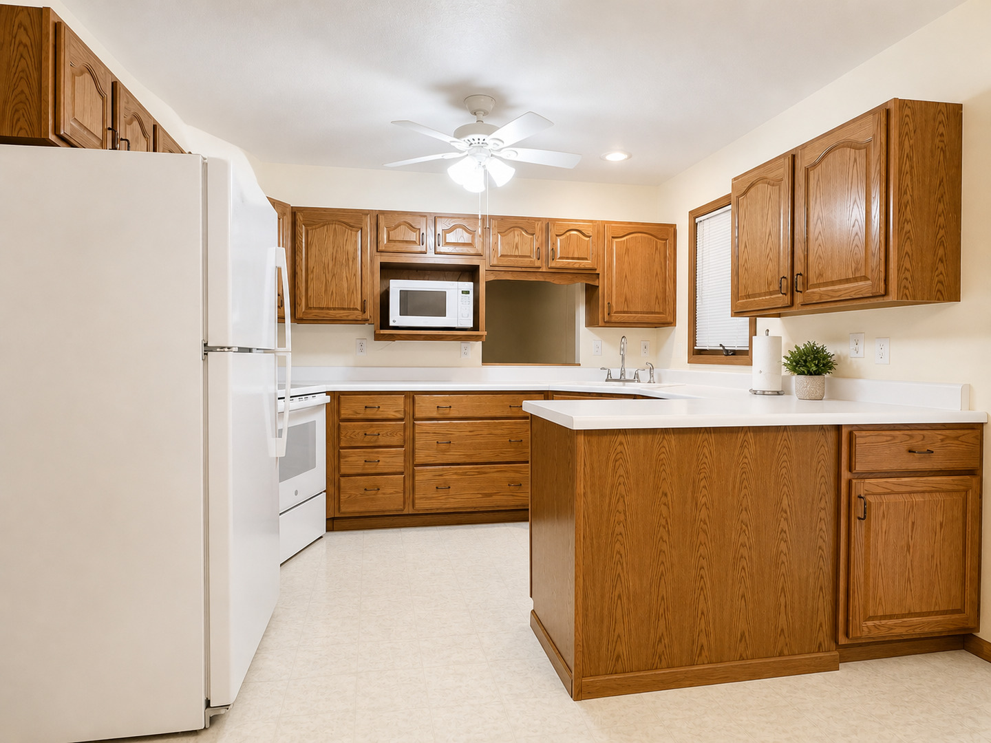 2608 38th Street Moline, IL 61265 - Photo 6 of 18 a kitchen with granite countertop a refrigerator a sink stainless steel appliances and cabinets