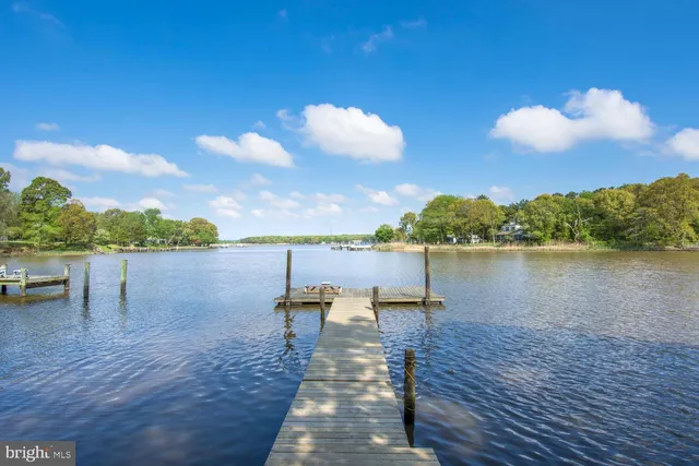 a lake view with a table and chairs