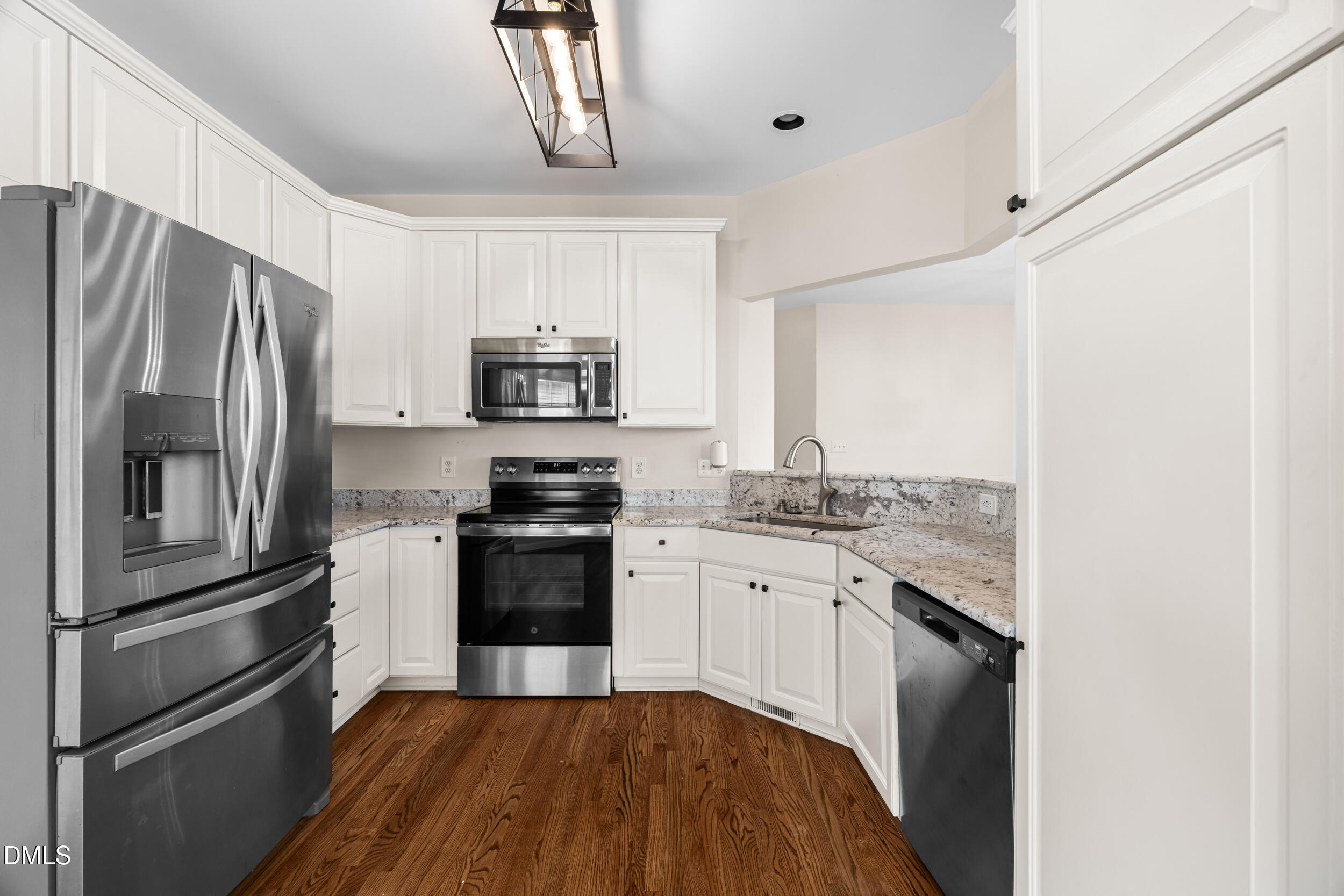 744 Seastone Street Raleigh, NC 27603 - Photo 23 of 53 a kitchen with granite countertop a refrigerator stove and sink