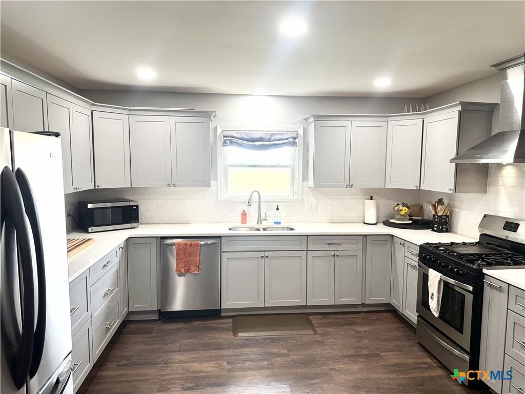 1045 Arnold Road Victoria, TX 77905 - Photo 6 of 15 a kitchen with stainless steel appliances a sink stove and refrigerator
