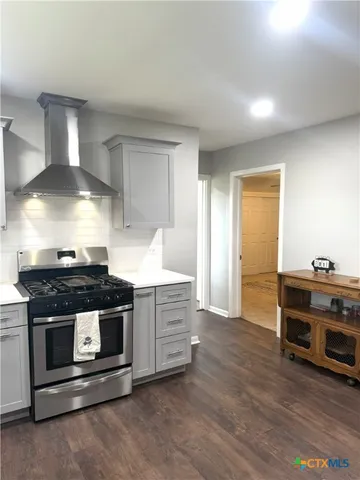 a kitchen with a stove and a sink