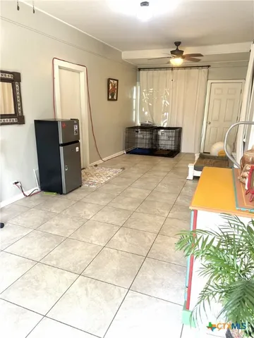 a living room with a bed and a table