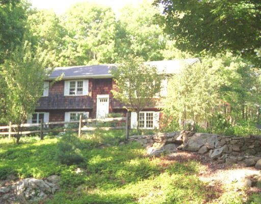 52 Pheasant Ridge Road Redding, CT 06896 - Photo 1 of 1 a front view of a house with a yard