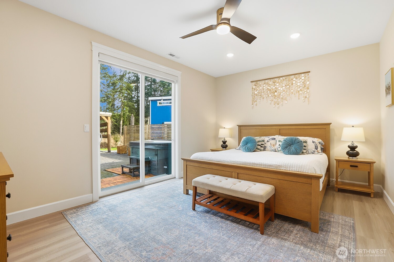 3237 Hilberg Lane Clinton, WA 98236 - Photo 15 of 40 a spacious bedroom with a bed and glass door