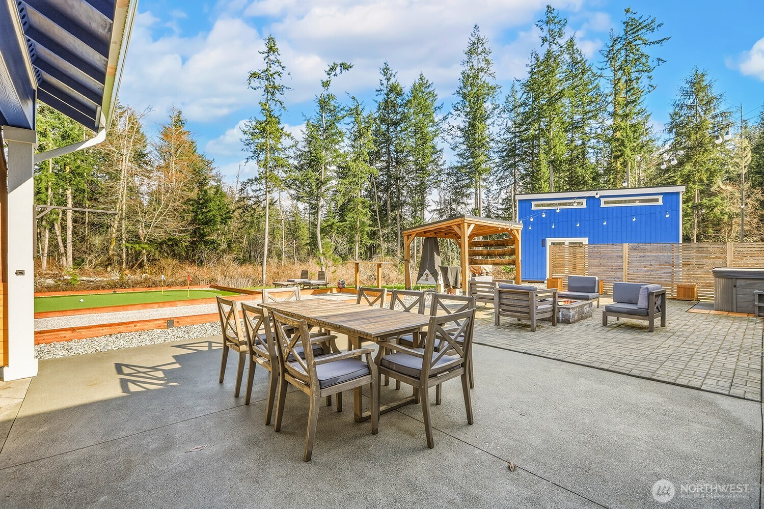3237 Hilberg Lane Clinton, WA 98236 - Photo 20 of 40 a view of a patio with table and chairs and potted plants