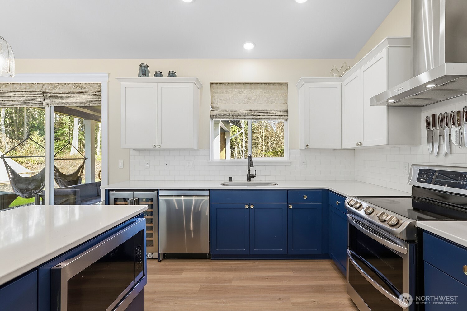 3237 Hilberg Lane Clinton, WA 98236 - Photo 9 of 40 a kitchen with stainless steel appliances granite countertop a sink a stove a counter space and cabinets