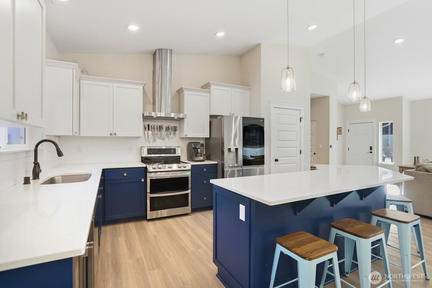 3237 Hilberg Lane Clinton, WA 98236 - Photo 10 of 40 a large kitchen with stainless steel appliances a stove a sink a oven a dining table and chairs