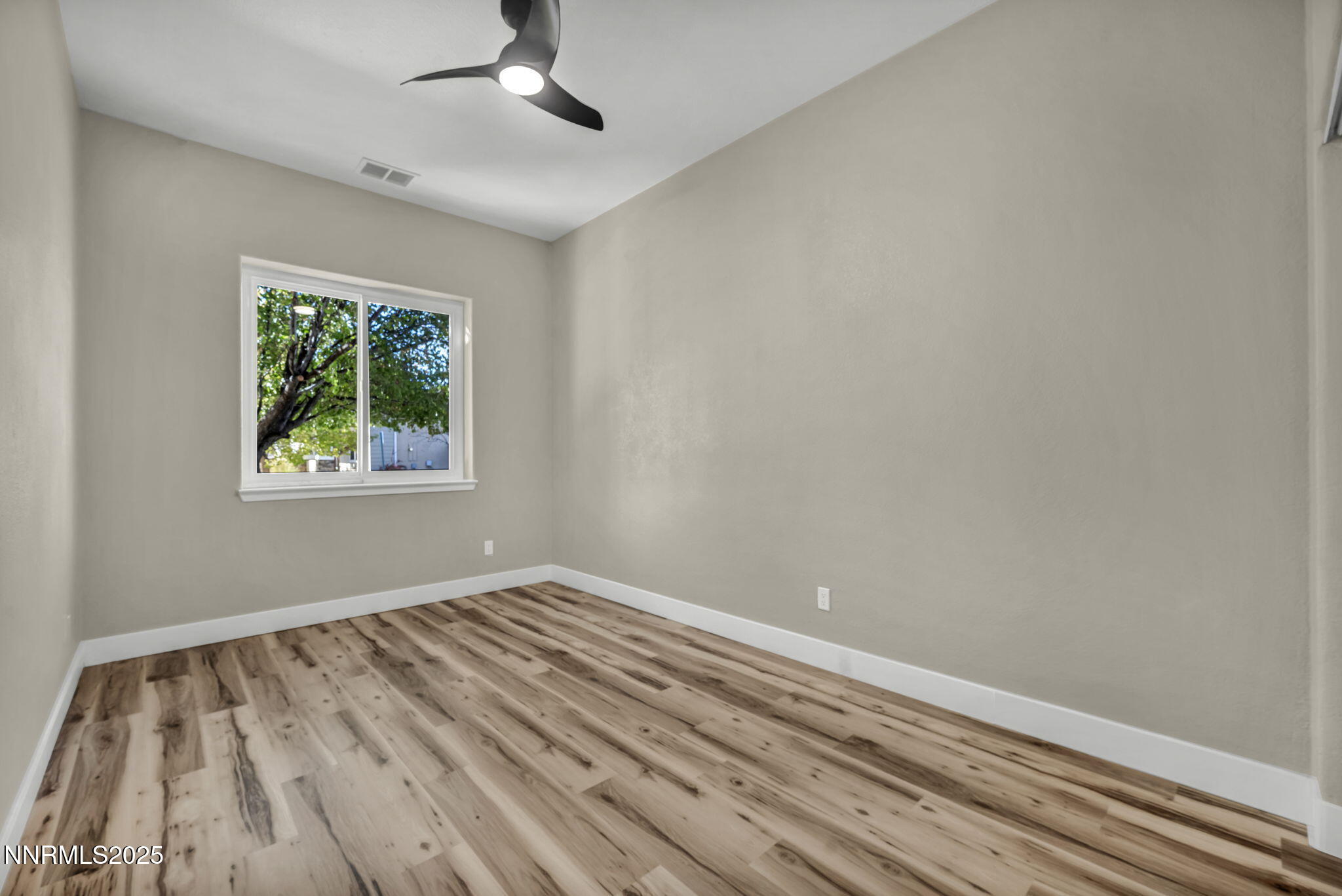 1781 Emerald Bay Drive Reno, NV 89521 - Photo 22 of 42 wooden floor in an empty room with a window