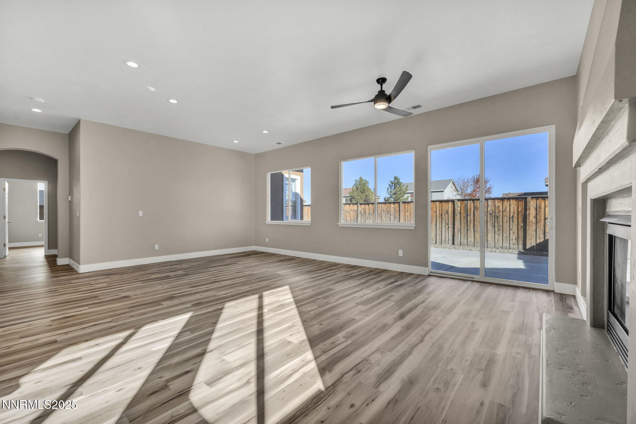 1781 Emerald Bay Drive Reno, NV 89521 - Photo 7 of 42 a view of an empty room with a window and wooden floor