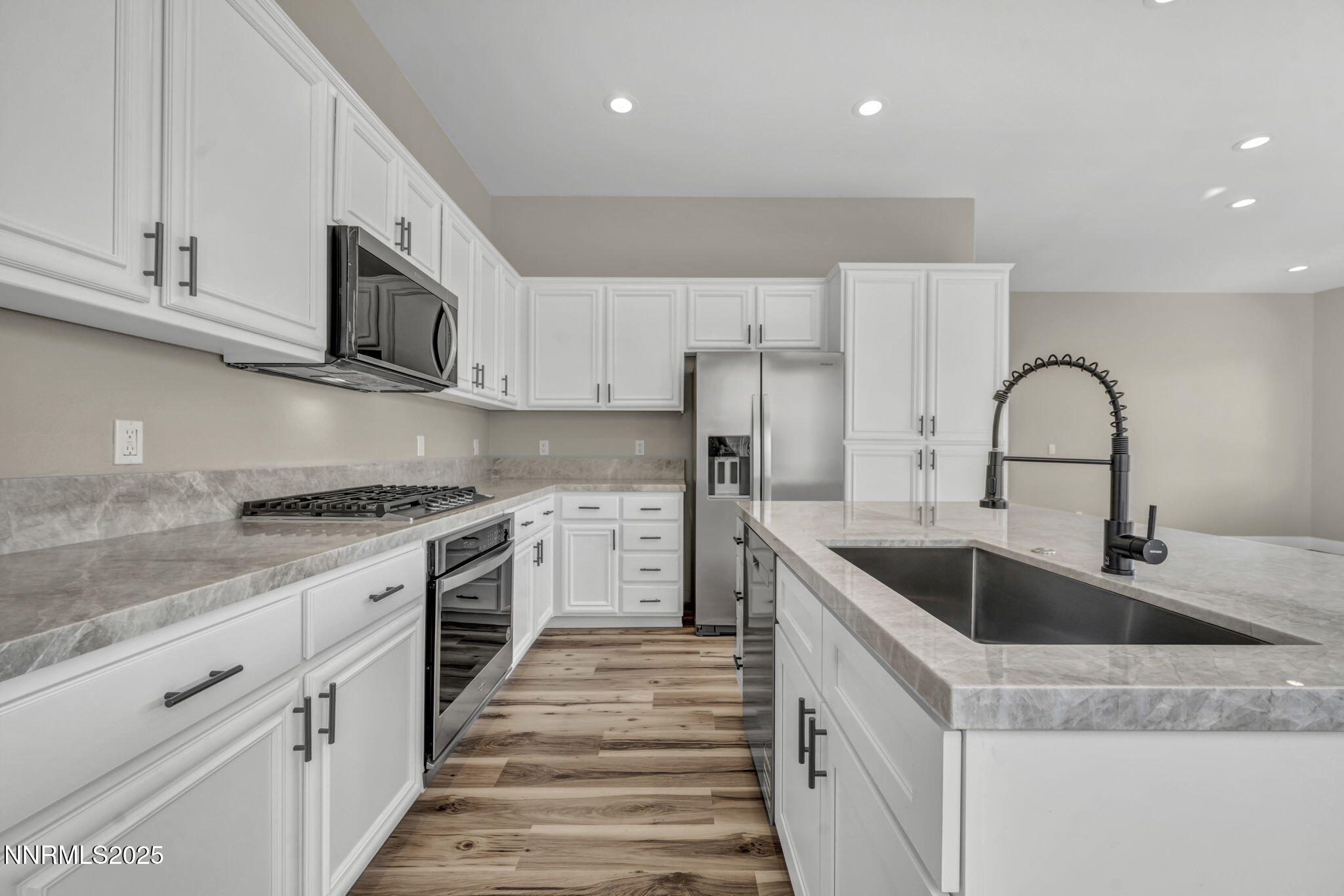 1781 Emerald Bay Drive Reno, NV 89521 - Photo 9 of 42 a kitchen with stainless steel appliances granite countertop a sink and cabinets